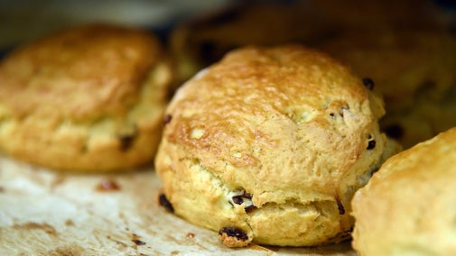 Fruit scones on baking parchment on a baking tray